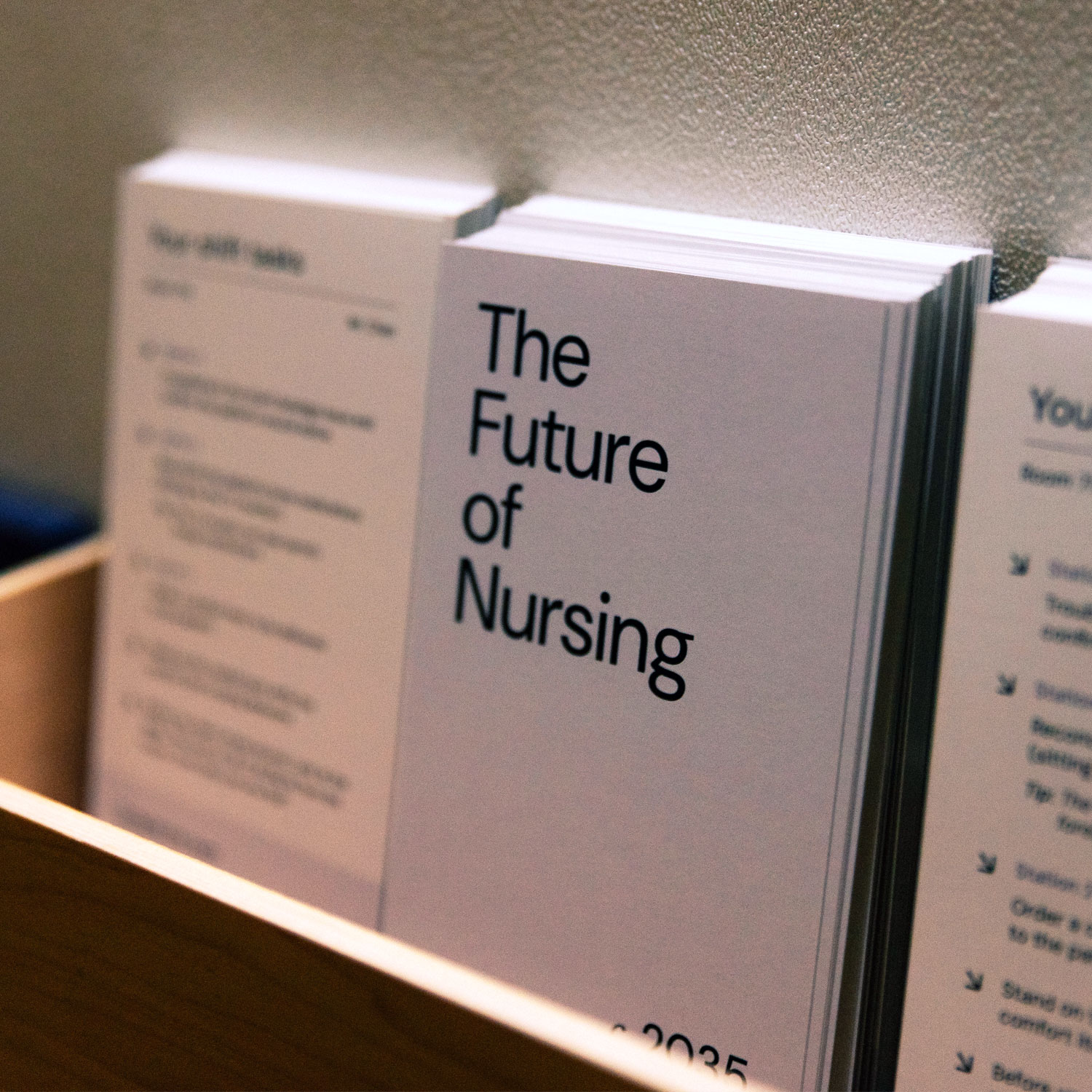 A row of printed booklets titled &lsquo;The Future of Nursing 2035,&rsquo; available inside the prototype environment as reference material for participants.