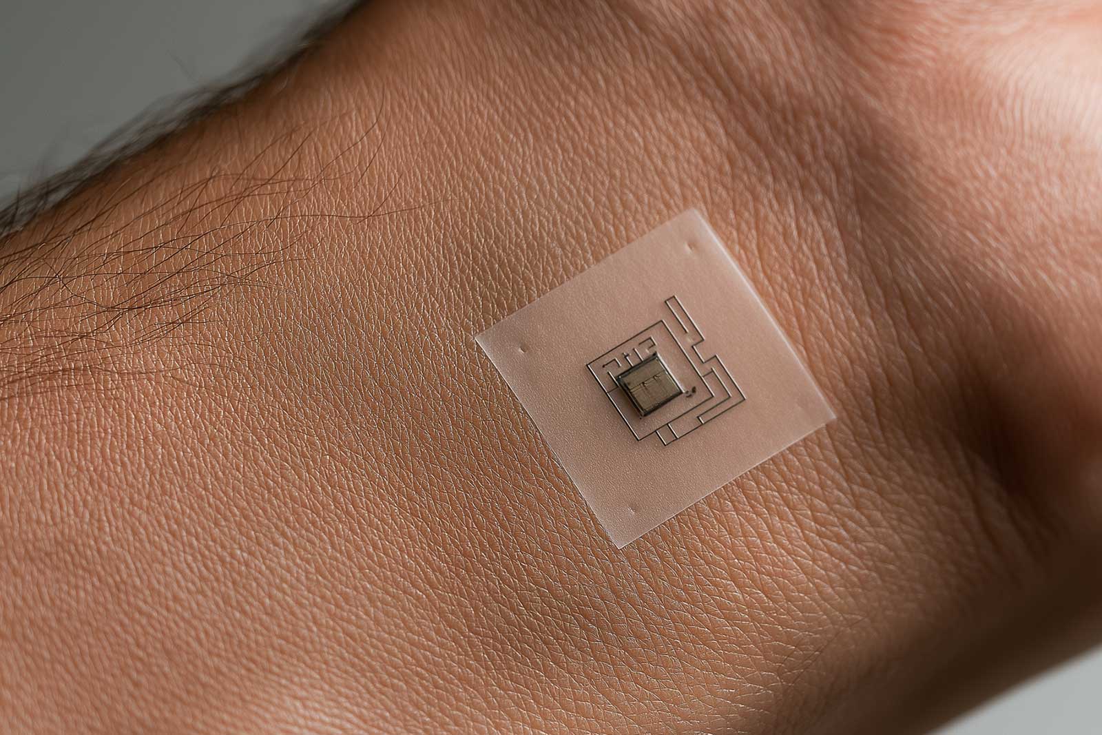 A thin skin-applied biosensor patch with no visible battery or wires